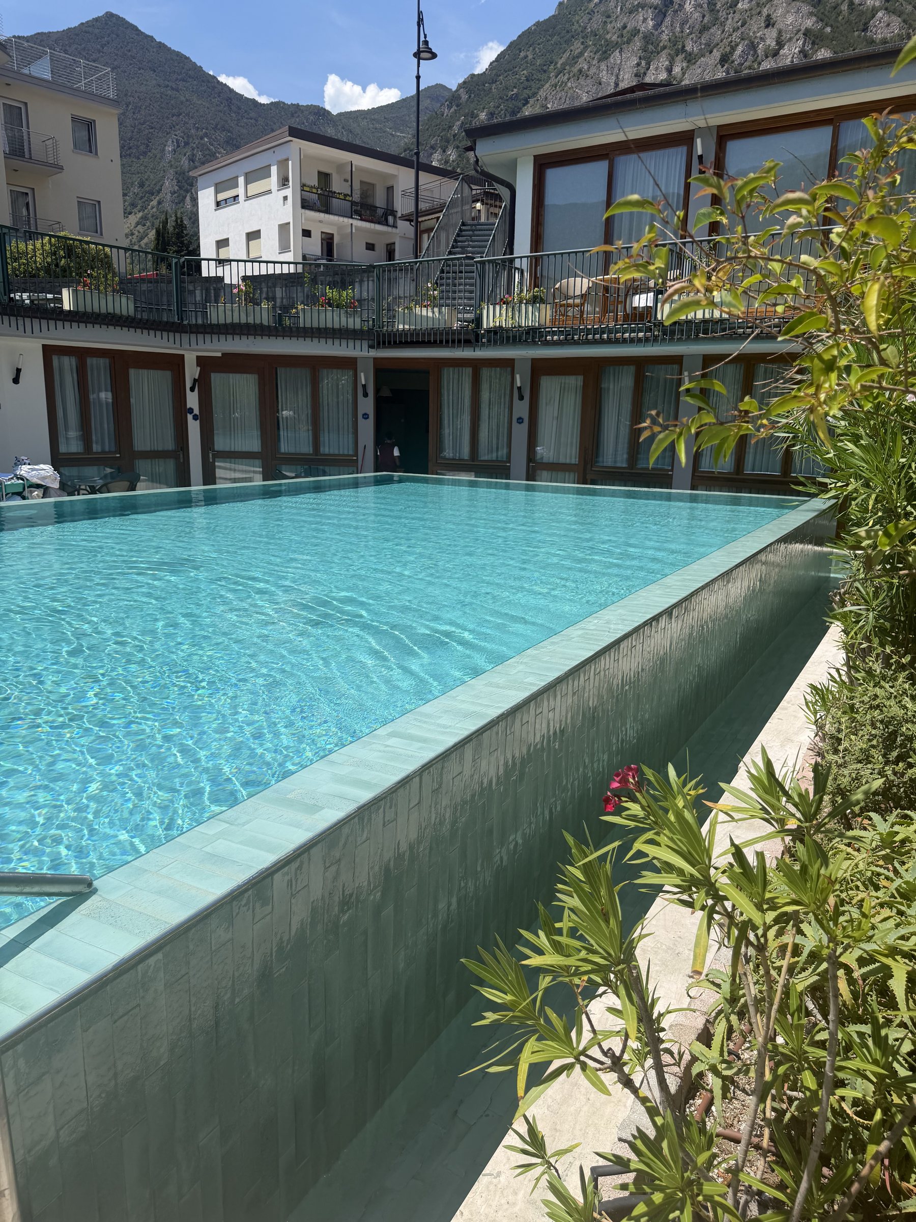 Outdoor pool at Hotel Alexander with mountain views